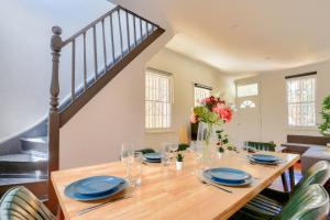 a dining room with a wooden table and a staircase at 3 Bedroom House Chippendale Near the Center 2 E-Bikes Included in Sydney