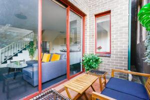 a patio with a blue couch and a table at Cozy 2 Bedroom Apartment Chippendale II in Sydney