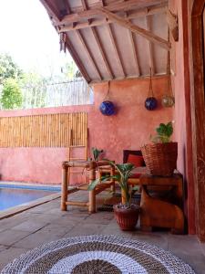 a patio with a table and chairs on a porch at Villa Sea La Vie Private pool in Gili Meno