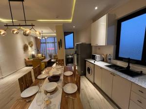 a kitchen with a dining table with plates on it at Spacious 2 BR apartment near the airport in Addis Ababa