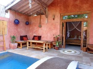a house with a swimming pool and a patio at Villa Sea La Vie Private pool in Gili Meno