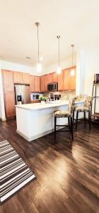 a large kitchen with a white counter and chairs at Adorable 5star Luxury Living in Houston