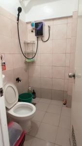 a bathroom with a toilet and a shower at Min Hao&Xin Transient in Manila