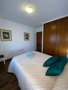 a bedroom with a large bed with blue pillows at franlau in Mora de Rubielos