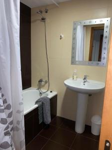 a bathroom with a sink and a bath tub at franlau in Mora de Rubielos