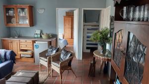 a kitchen and living room with a table and chairs at Betty's Bay Holiday home in Clareport