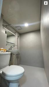 un baño con inodoro y lavabo en FUNDI Hotel, en Tainan