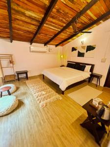 um quarto com uma cama e um tecto de madeira em Gypsy Stays- Aakhet Farms em Beohāri
