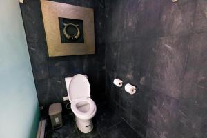 a bathroom with a toilet and two rolls of toilet paper at Andersson Beach House Cebu in Compostela