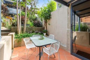 a patio with a table and chairs on a patio at Balmain Retreat - 2BR + Study in Sydney