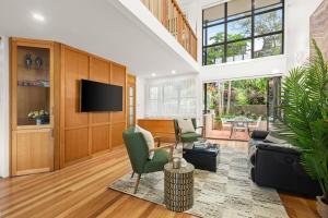 a living room with a couch and a tv at Balmain Retreat - 2BR + Study in Sydney