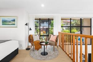 a bedroom with a bed and a balcony with a table and chairs at Balmain Retreat - 2BR + Study in Sydney