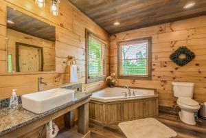 a bathroom with a tub and a toilet and a sink at Freedoms View, Game Room & Amazing Views, FREE tickets each paid day, Hot Tub!!! in Sevierville +73 photos
