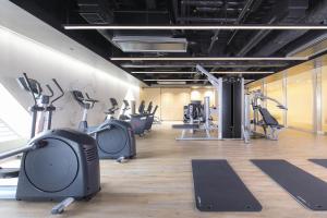a gym with several treadmills and cardio machines at Tokyo Dome Hotel in Tokyo