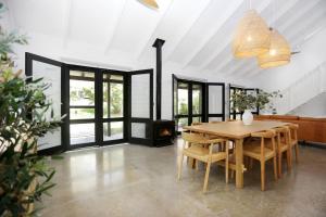 a dining room with a wooden table and chairs at Hawks Nest Hideaway in Hawks Nest +19 photos