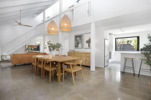a kitchen and dining room with a table and chairs at Hawks Nest Hideaway in Hawks Nest