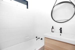 a bathroom with a white sink and a mirror at Hawks Nest Hideaway in Hawks Nest
