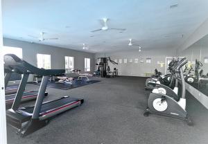 a gym with several exercise bikes and treadmills at Ipoh Water Park(14pax) Homestay@HopeStay in Ipoh