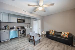 a living room with a couch and a kitchen at Modern Updated Condo Near Downtown in Washington