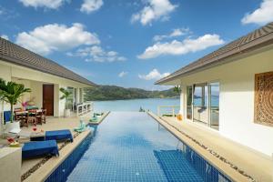 a villa with a swimming pool and a view of the water at Stunning 5 bedrooms Villa with Panoramic Sea View in Por Bay