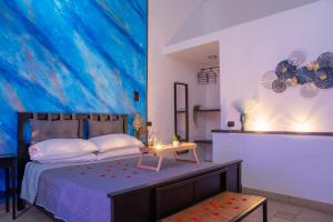 a bedroom with a bed with a large painting on the wall at B&B La Sorgente in Brindisi +31 photos
