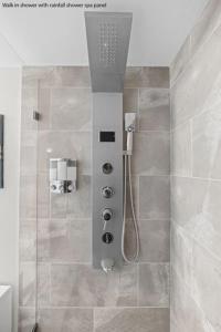 a shower with a shower head in a bathroom at Beautiful Bright Modern Condo with Water view and AC in DT Vancouver 2BR,3BD,2BT sleeps 6 guests Free parking Netflix Included in Vancouver