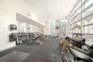 a gym with treadmills and machines in a room at Beautiful Bright Modern Condo with Water view and AC in DT Vancouver 2BR,3BD,2BT sleeps 6 guests Free parking Netflix Included in Vancouver