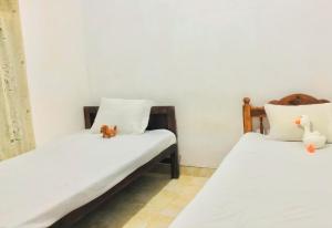 Ένα ή περισσότερα κρεβάτια σε δωμάτιο στο Grand Refuge Holiday Rooms