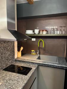 a kitchen with a sink and a counter top at CLOCKWORKORANGE Luxury Suites in Mactan