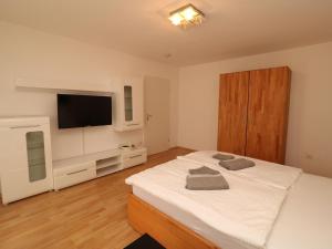 a bedroom with a bed and a flat screen tv at Property in Essen in Essen