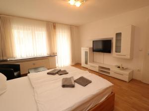 a bedroom with a large bed with two towels on it at Property in Essen in Essen