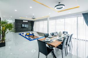 a dining room with a table and chairs at Mango Hill Residence in Rawai Beach