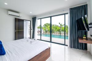 ラワイビーチにあるMango Hill Residenceのベッドルーム1室(大型ベッド1台付)、スイミングプールが備わります。