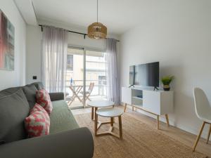a living room with a couch and a tv at Pascal Home By CanariasGetaway in Las Palmas de Gran Canaria