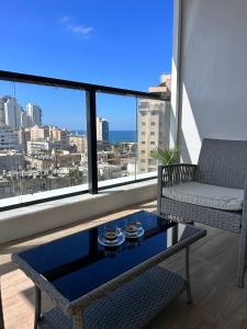 a living room with a couch and a coffee table at Sea Breeze Netanya Retreat by Sea N' Rent in Netanya