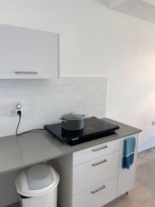 a kitchen counter with a pot on a stove at Sea Breeze Netanya Retreat by Sea N' Rent in Netanya