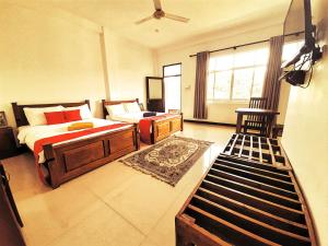 a bedroom with a bed and a chair and a window at Royal Bath Edge in Kandy
