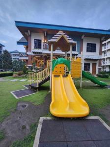 a playground with a slide in front of a building at 2BR Tagaytay Affordable staycation in Tagaytay
