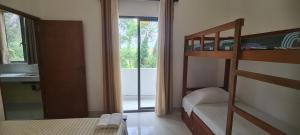 a bedroom with a bunk bed and a bathroom at Ceylon Lodge - Airport Transit Hotel & Hostel in Negombo