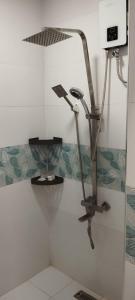 a shower in a bathroom with a shower head at Evexia Garden in Santa Rosa