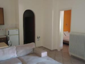 a living room with a couch and a bedroom at Almini2 Apartments in Plataria