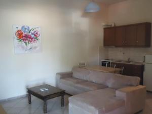a living room with a couch and a table at Almini2 Apartments in Plataria