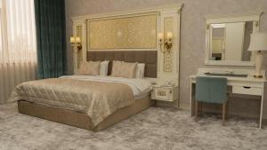 a bedroom with a bed and a desk and a mirror at DiliMah Premium Luxury in Samarkand