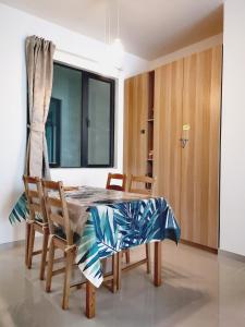 a dining room with a table and chairs and a window at Trival The Elegant Retreat Forest City, Johor Bahru in Johor Bahru