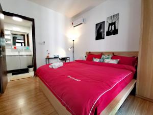 a bedroom with a large bed with a red blanket at Trival The Elegant Retreat Forest City, Johor Bahru in Johor Bahru +49 photos