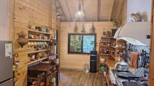 a kitchen with wooden walls and a counter in a room at Sali Mu Homestay in Taian