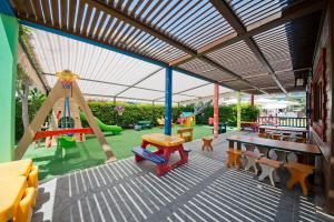 a play area with a playground with a swing at Aydinbey King's Palace & Spa - Ultra All Inclusive in Side