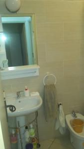 a bathroom with a sink and a mirror and a toilet at Apartamento en Tetuán in Tetouan