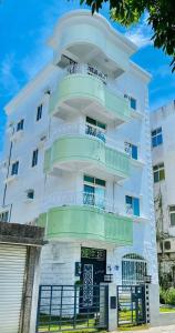 a white building with balconies on it at Green Stay in Hualien City