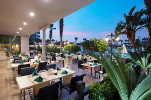 a restaurant with tables and chairs in a building at Aydinbey King's Palace & Spa - Ultra All Inclusive in Side